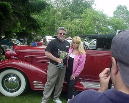 Dick and Nancy Shappy posing with the 1933 Cadillac V-16 Convertible Coupe  and the "Best Of Show" trophy, July 5, 2005.
